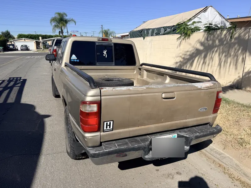 Tan Ford Ranger pickup, rear three-quarter view